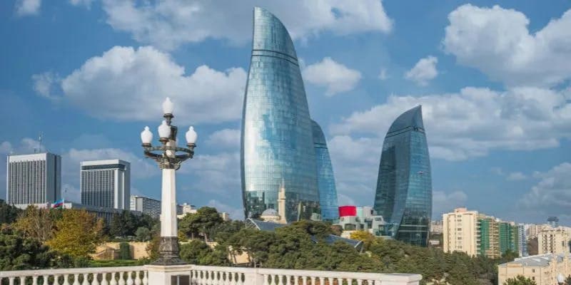 View of modern glass skyscrapers in Baku, Azerbaijan, under a blue sky