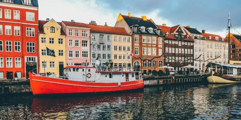 Colorful buildings and red boat in canal in Denmark
