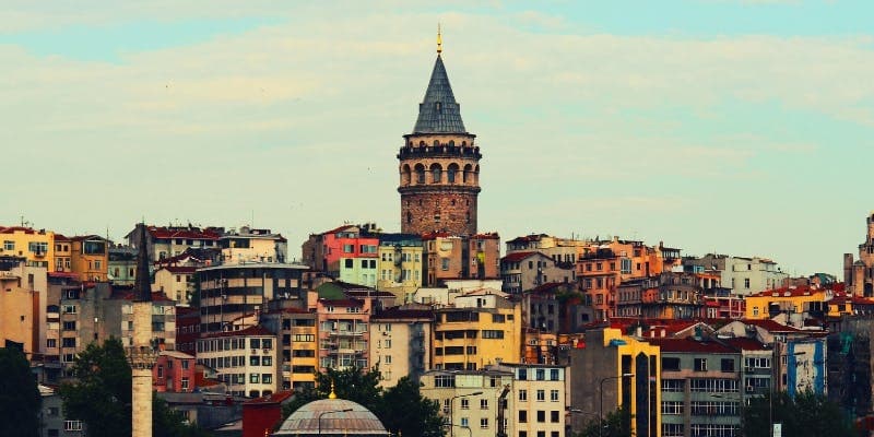 Galata Tower standing tall above colorful buildings in Istanbul, a key site for travelers with a Turkey business visa.