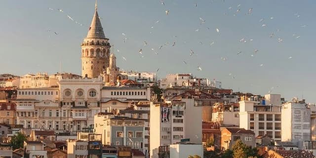 Galata Tower amidst residential buildings in Istanbul, Turkey, representing the ideal destination for Indians with a Turkey sticker visa.