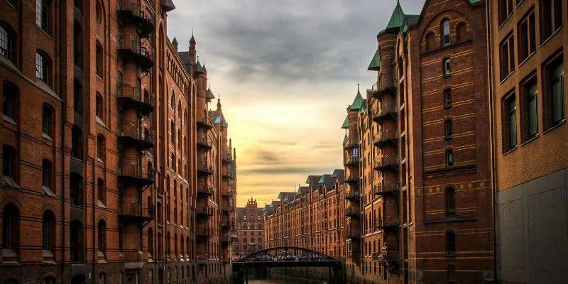 Gothic warehouses along canal at sunset in Hamburg.