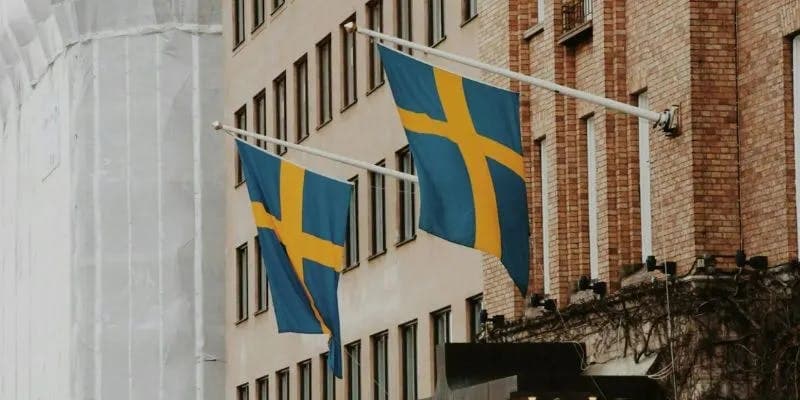 Sweden's flags raised against beautiful Swedish buildings