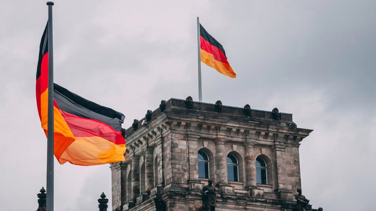 German flags waving atop a historic building