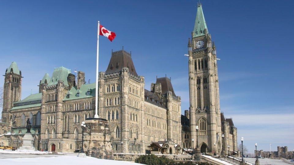 This image shows Canada's Parliament Buildings with the national flag.