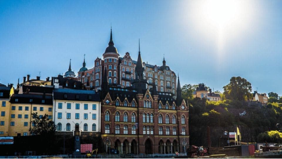 Colorful buildings on a hill with a bright blue sky.