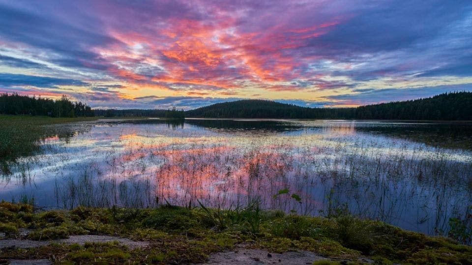 Serene sunset over a calm, reflective lake