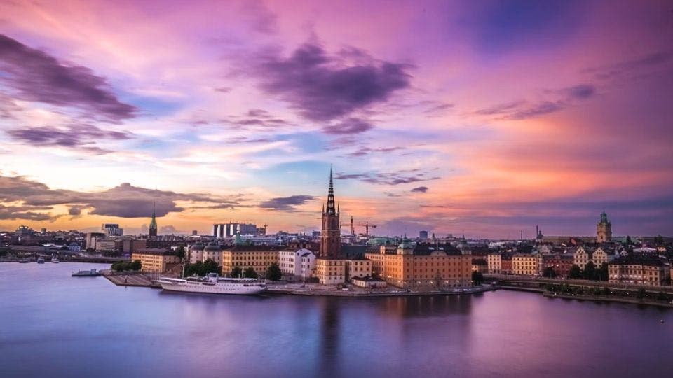 Sunset view of Stockholm cityscape by water