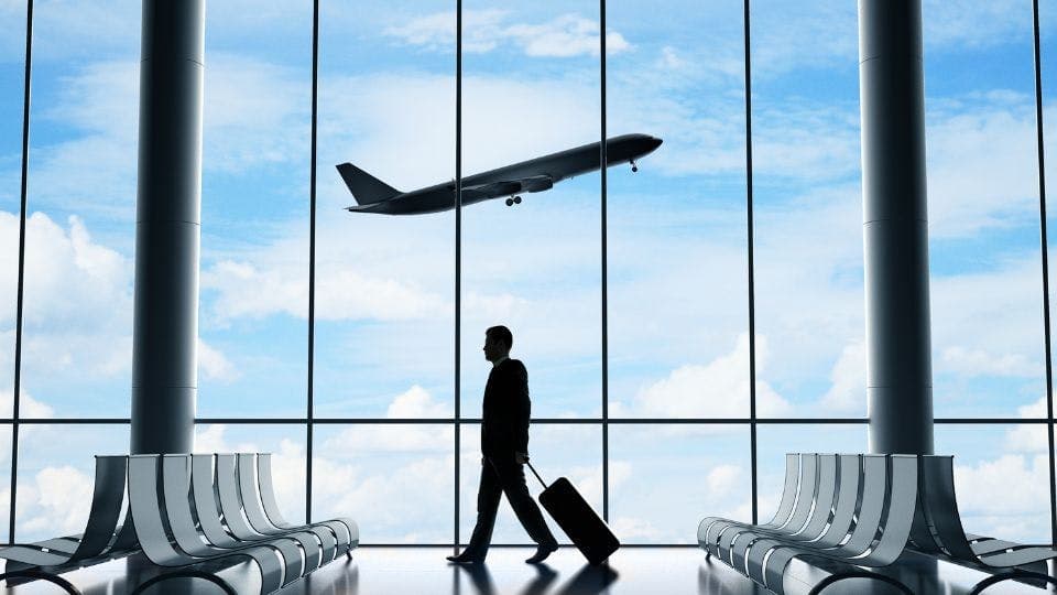 A man with his luggage in airport.