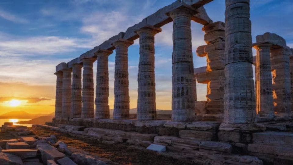 Ancient Greek temple ruins at sunset.