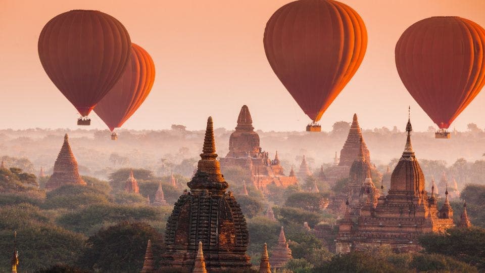 Hot air balloons over ancient temples.