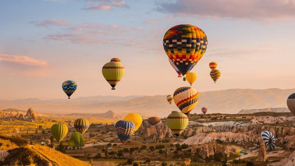 Hot air balloons over Cappadocia landscape